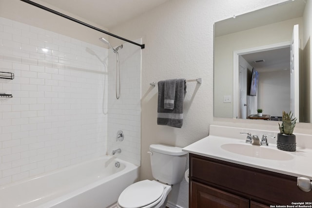 full bathroom with tiled shower / bath, vanity, and toilet