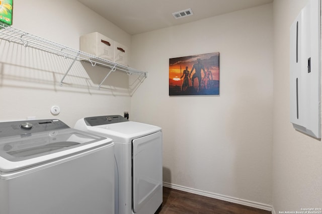 laundry room featuring dark hardwood / wood-style flooring and washing machine and dryer