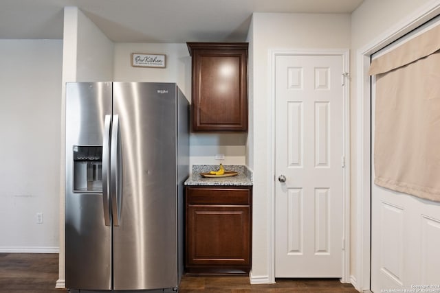 kitchen with stainless steel fridge, dark hardwood / wood-style flooring, and dark brown cabinetry