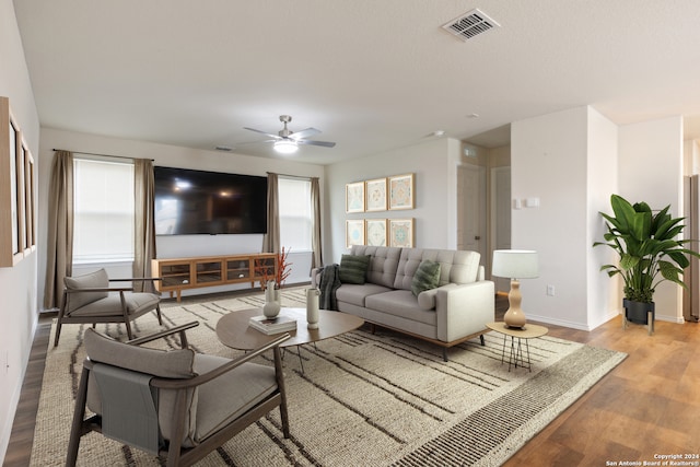 living room with ceiling fan and light hardwood / wood-style flooring