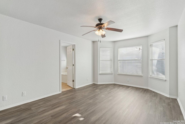 unfurnished room with hardwood / wood-style flooring, ceiling fan, and a textured ceiling