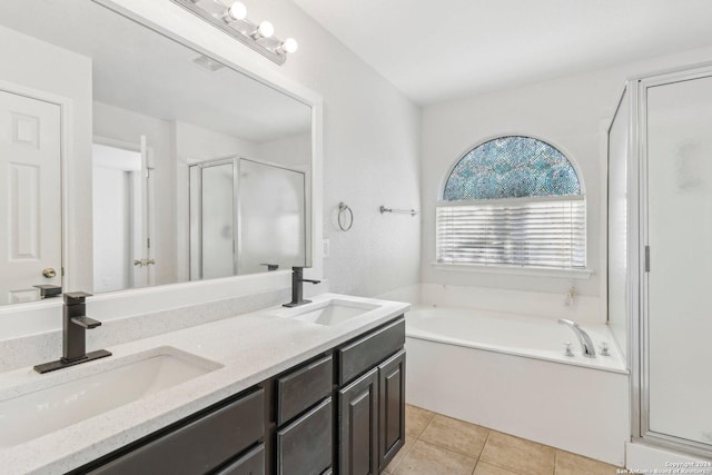 bathroom featuring tile patterned floors, vanity, and plus walk in shower