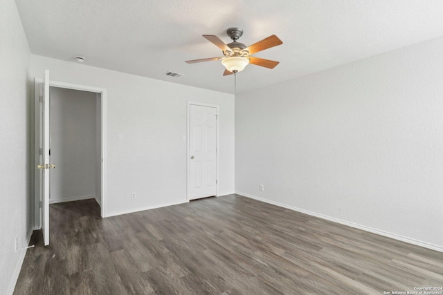 unfurnished bedroom with ceiling fan and dark hardwood / wood-style flooring