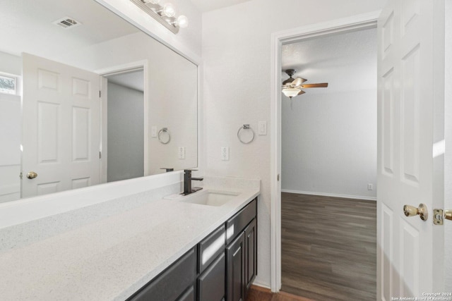 bathroom with ceiling fan, vanity, and wood-type flooring