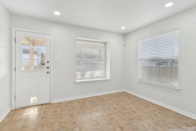 foyer entrance featuring plenty of natural light and light tile patterned flooring