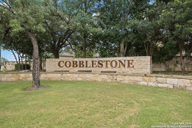 community / neighborhood sign with a lawn