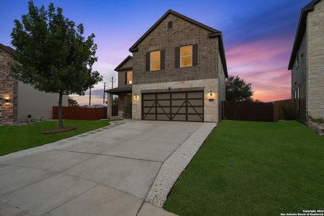 view of front facade featuring a lawn and a garage