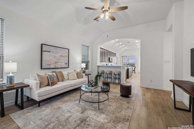 living room featuring hardwood / wood-style floors, ceiling fan, and lofted ceiling