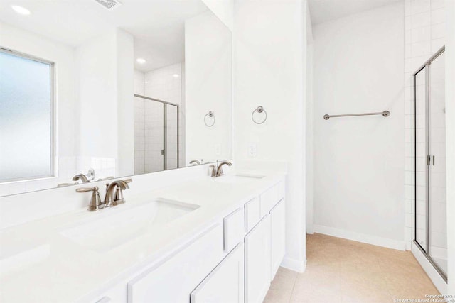 bathroom with vanity, tile patterned floors, and a shower with shower door