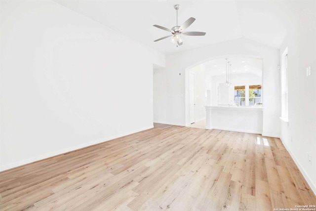 unfurnished living room with ceiling fan, light hardwood / wood-style floors, and lofted ceiling