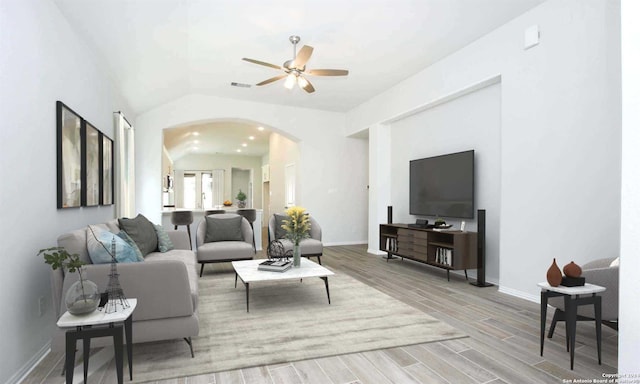 living room with lofted ceiling, ceiling fan, and wood-type flooring