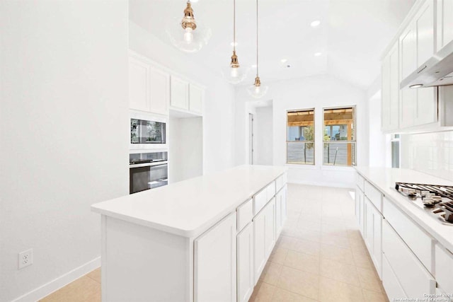 kitchen featuring appliances with stainless steel finishes, white cabinetry, a kitchen island, and pendant lighting