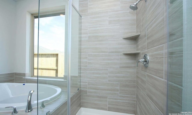 bathroom featuring separate shower and tub and plenty of natural light