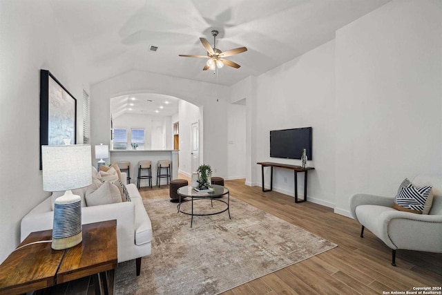 living room featuring hardwood / wood-style floors, ceiling fan, and vaulted ceiling