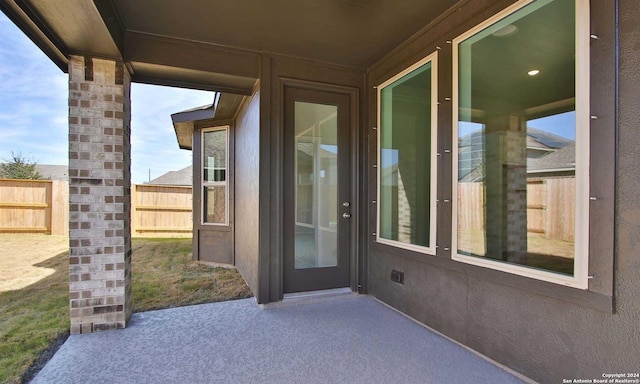 doorway to property with a patio area