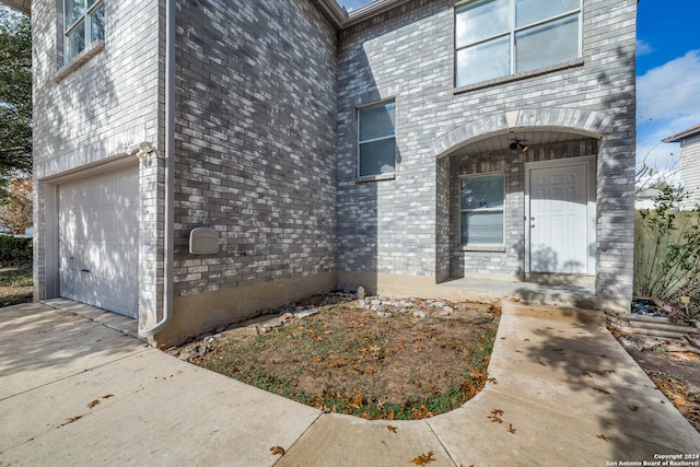 view of exterior entry with a garage