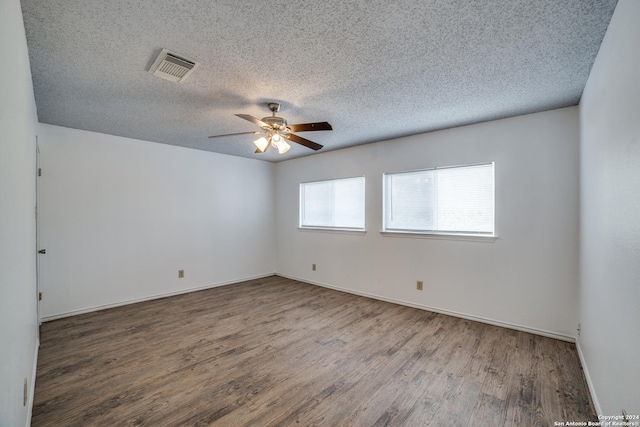 empty room with hardwood / wood-style floors, a textured ceiling, and ceiling fan