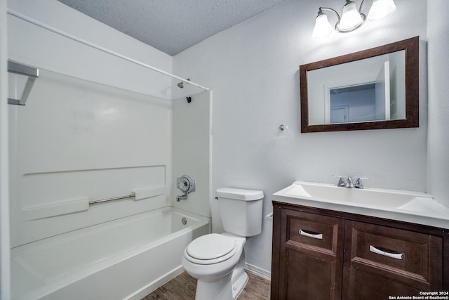 full bathroom featuring hardwood / wood-style floors, shower / bathing tub combination, vanity, toilet, and a textured ceiling