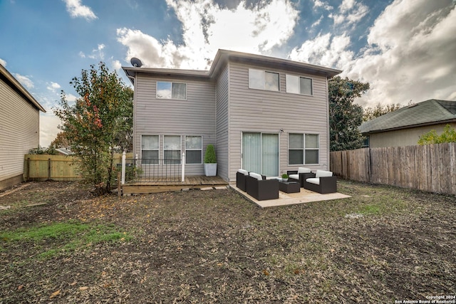 rear view of house featuring an outdoor living space, a patio area, and a wooden deck