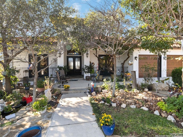 view of front of home with french doors and a garage