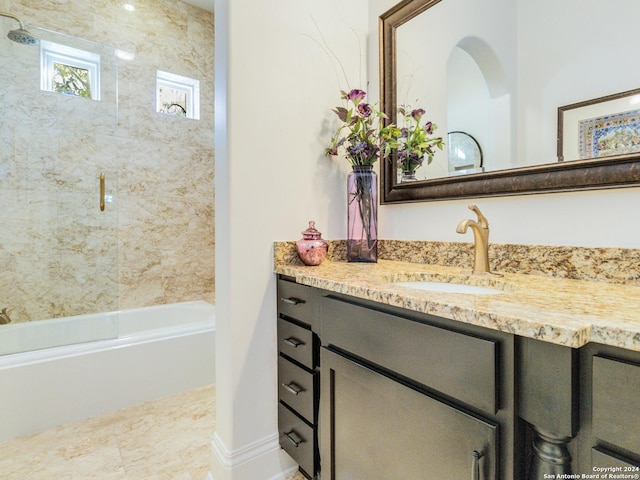 bathroom with vanity and tiled shower / bath