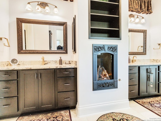 bathroom with built in shelves, vanity, and tile patterned floors