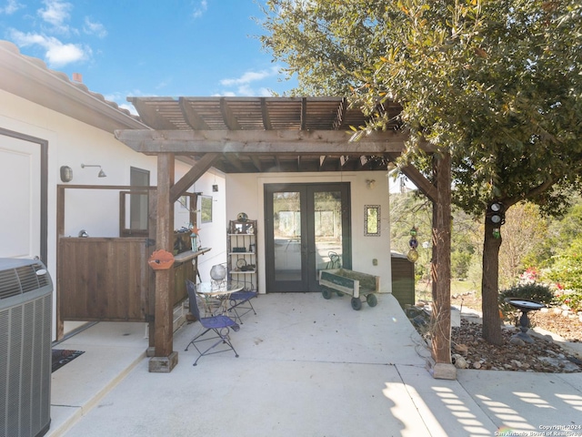 doorway to property featuring a patio area, a pergola, french doors, and central air condition unit