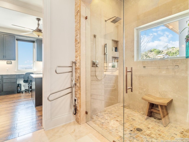 bathroom with walk in shower, crown molding, and ceiling fan