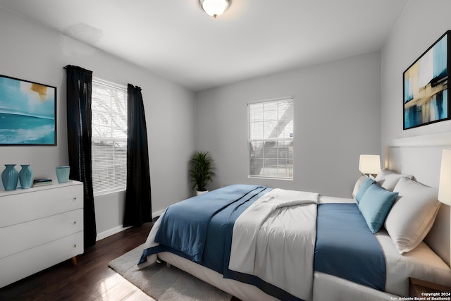 bedroom featuring dark hardwood / wood-style floors and multiple windows