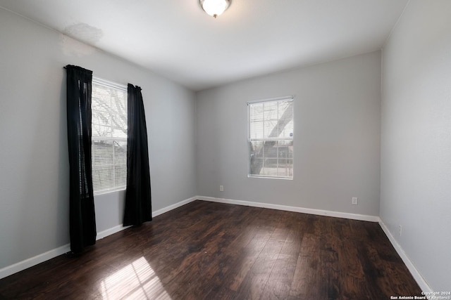 spare room featuring dark wood-type flooring