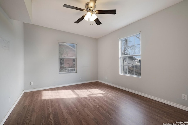 spare room with ceiling fan and dark hardwood / wood-style flooring