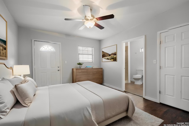 bedroom featuring ceiling fan, dark hardwood / wood-style floors, and connected bathroom