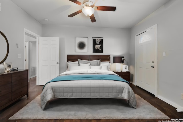 bedroom with ceiling fan and dark wood-type flooring