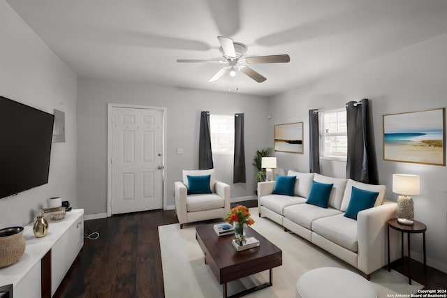 living room with dark hardwood / wood-style floors and ceiling fan