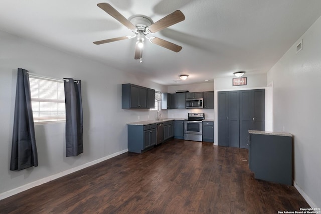 kitchen featuring gray cabinetry, ceiling fan, sink, stainless steel appliances, and dark hardwood / wood-style floors