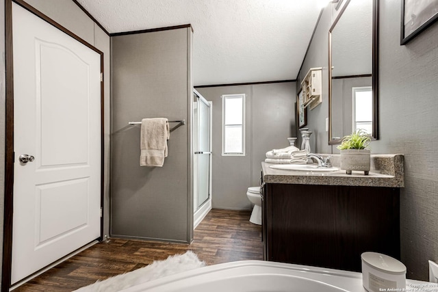 bathroom featuring a healthy amount of sunlight, toilet, wood-type flooring, and crown molding