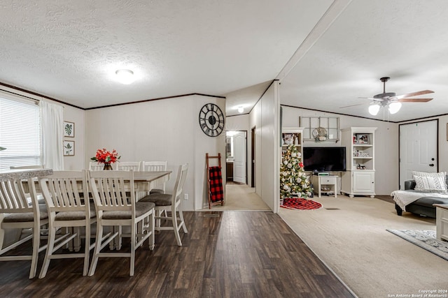 dining area with a textured ceiling, ceiling fan, crown molding, hardwood / wood-style floors, and lofted ceiling