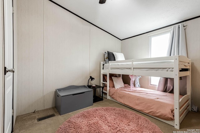 bedroom featuring multiple windows, ceiling fan, light carpet, and lofted ceiling