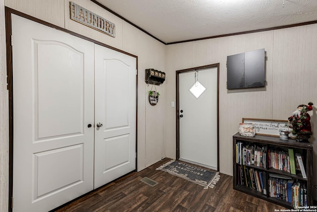 entrance foyer featuring dark hardwood / wood-style flooring and a textured ceiling