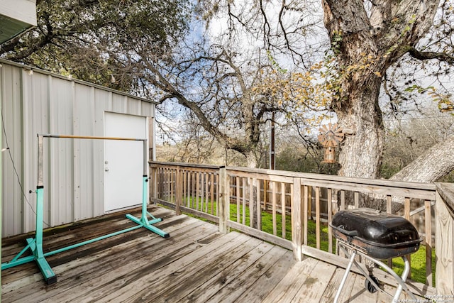 wooden deck featuring a grill