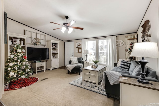 carpeted living room with crown molding, ceiling fan, and vaulted ceiling