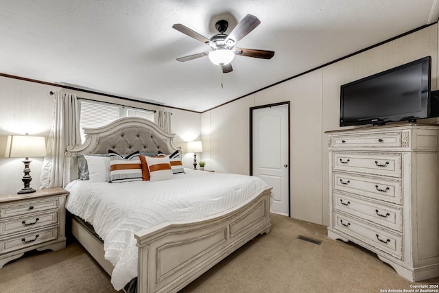 carpeted bedroom with ceiling fan, crown molding, and lofted ceiling