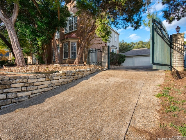 view of side of property featuring an outbuilding and a garage