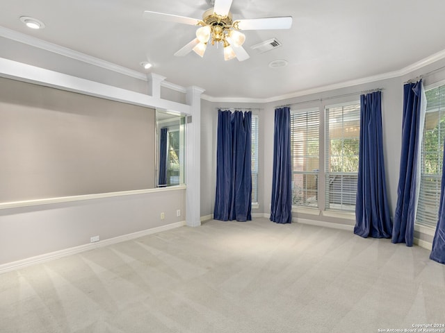 carpeted spare room with crown molding and ceiling fan