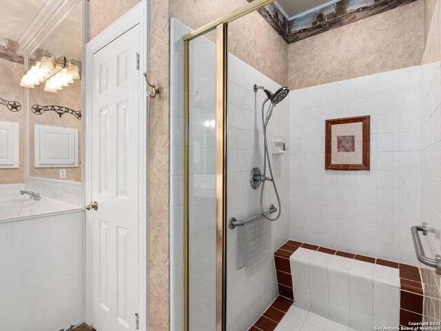 bathroom featuring vanity, an enclosed shower, and crown molding