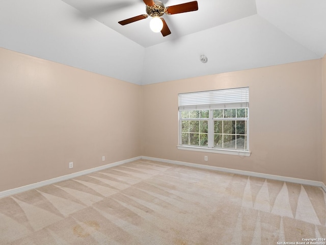 carpeted empty room with ceiling fan and lofted ceiling