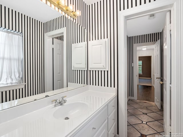 bathroom with tile patterned floors and vanity