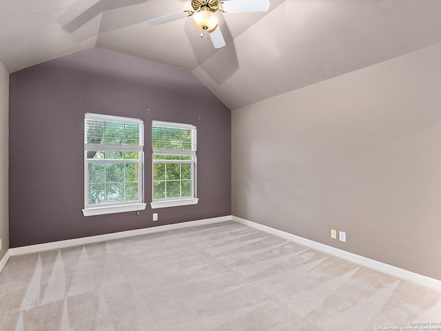 interior space with light carpet, ceiling fan, and vaulted ceiling