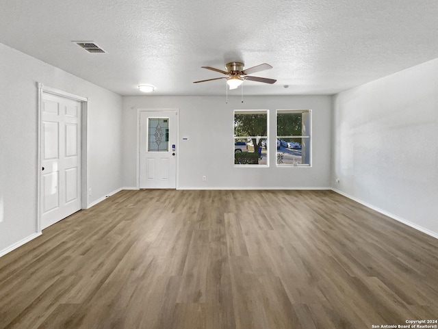 interior space featuring a textured ceiling, dark hardwood / wood-style flooring, and ceiling fan