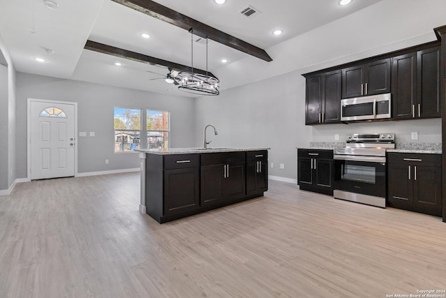 kitchen featuring sink, light wood-type flooring, decorative light fixtures, beam ceiling, and stainless steel appliances